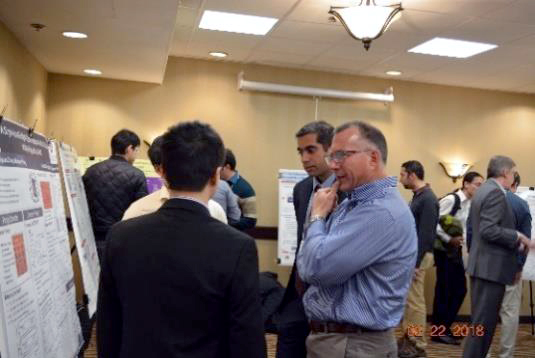 People talking around presentation boards